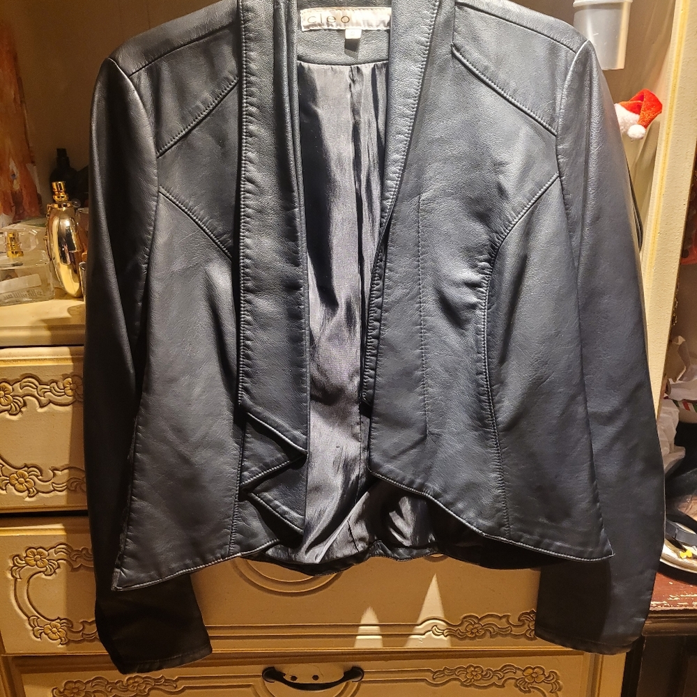 Faux leather jacket.  With material on arms. Very cute